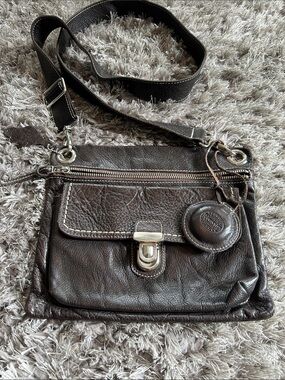 Roots Brown Leather Crossbody Bag with Brown Peace Charm